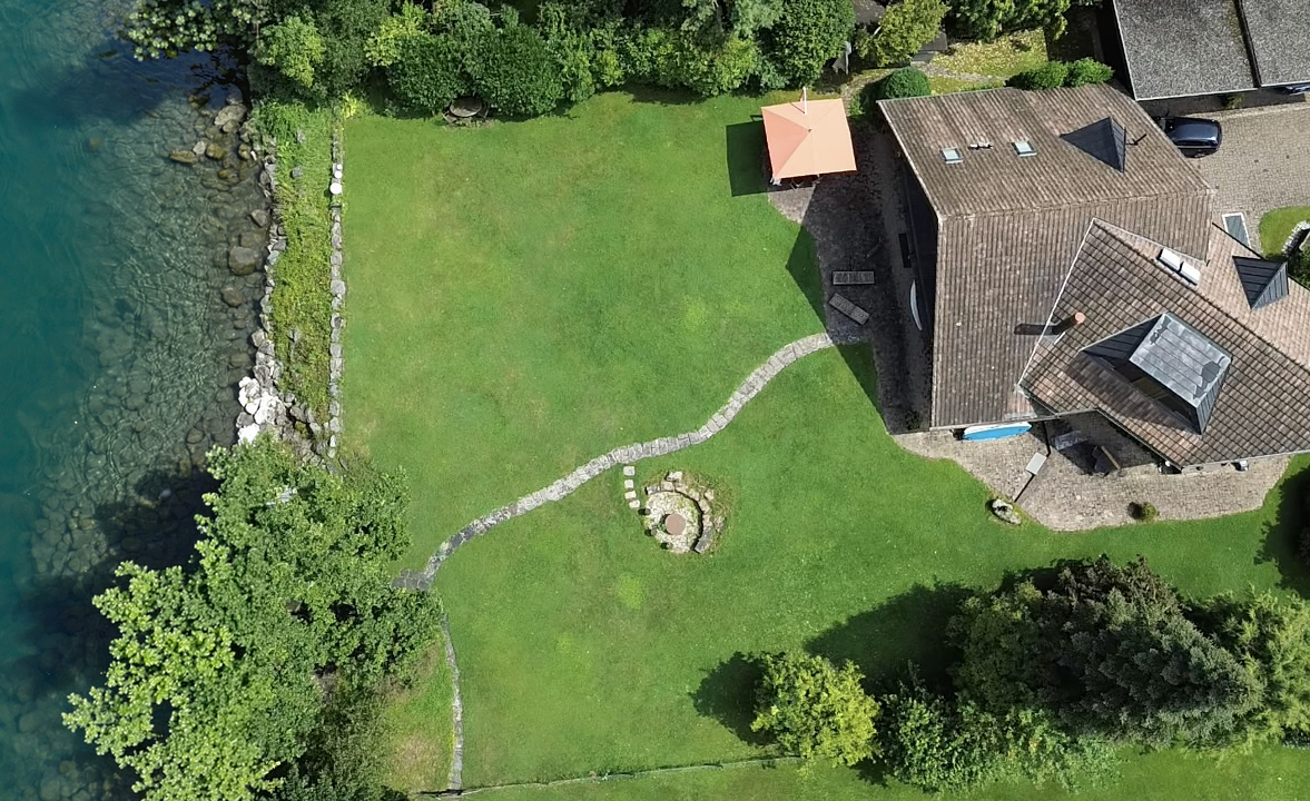 Blick vom See auf Garten und Ferienhaus